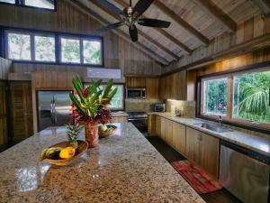 a kitchen with a counter with fruit on it at White Sand Beach, 3 Bedrooms House - Walking Distance To West End And West Bay in West Bay +62 photos