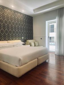 a bedroom with a large bed and a wall at Napoliday in Naples +32 photos