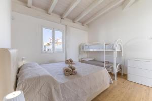 a bedroom with a bed and a bunk bed at Villa Maria con piscina riscaldata in Santa Maria Del Focallo +23 photos