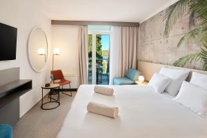 Posteľ alebo postele v izbe v ubytovaní Maistra Select Astarea Hotel