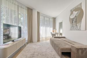 a living room with a large couch and a television at Home In 2 in Druskininkai