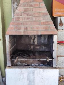 an old brick oven sitting next to a brick wall at 11Suites casa Suite #8 in Caraguatatuba