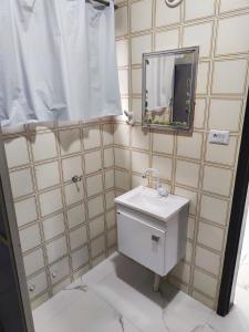 a bathroom with a toilet and a mirror at 11Suites casa Suite #8 in Caraguatatuba