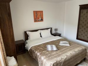 a bedroom with a bed with two pillows on it at Casa Dudu in Moieciu de Jos