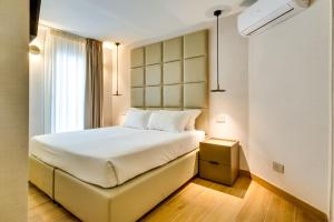 a hotel room with a bed and a window at Relais Badoer in Rome