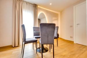 a table and chairs in a room with a window at Relais Badoer in Rome