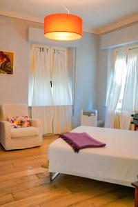 a bedroom with a white bed and a couch at Belle Viste - Boutique Apartments in Bettolle