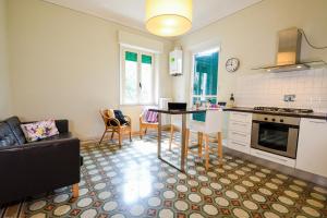 a kitchen and living room with a table and a couch at Belle Viste - Boutique Apartments in Bettolle