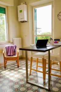 a dining room with a table and a laptop on it at Belle Viste - Boutique Apartments in Bettolle