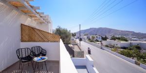 a balcony with two chairs and a table on the side of a building at Elia Pyrgos in Pyrgos