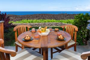 a wooden table with a bowl of food on it at 14B Halii Kai in Waikoloa