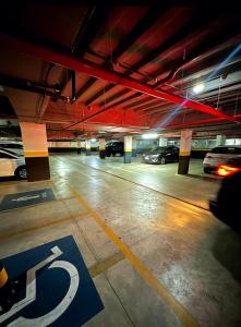 a parking lot with cars parked in a parking garage at Hotel Flat Afonso Pena in Campo Grande +120 photos