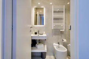 a bathroom with a sink and a toilet and a mirror at Relais Badoer in Rome