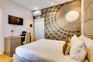 a hotel room with a bed and a desk at Relais Badoer in Rome
