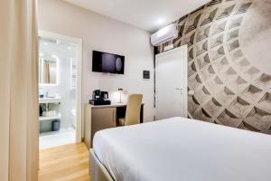 a hotel room with a bed and a bathroom at Relais Badoer in Rome