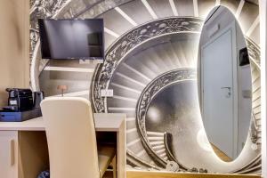 a spiral staircase mural in a room with a mirror at Relais Badoer in Rome