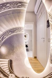 a spiral staircase in a house with a mirror at Relais Badoer in Rome