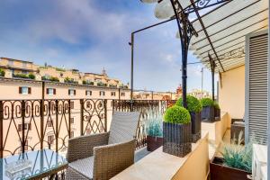 a balcony with chairs and a view of a building at Relais Badoer in Rome