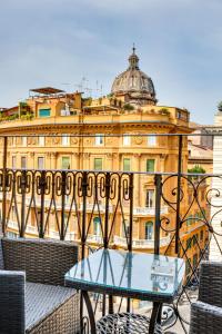 a glass table in front of a building at Relais Badoer in Rome