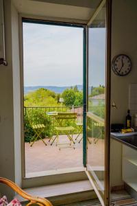a kitchen with a sliding glass door leading to a balcony at Belle Viste - Boutique Apartments in Bettolle
