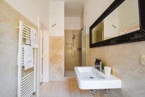 a bathroom with a white sink and a mirror at Belle Viste - Boutique Apartments in Bettolle