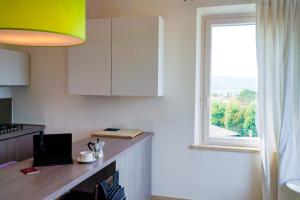 a kitchen with a counter top and a window at Belle Viste - Boutique Apartments in Bettolle