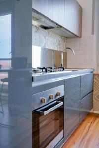 a kitchen with a sink and a stove at Belle Viste - Boutique Apartments in Bettolle