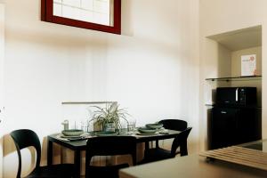 a dining room with a table and chairs at La Portesina Mantova in Mantova