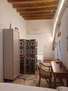 a living room with a table and a refrigerator at Casa Maranaty in Vejer de la Frontera
