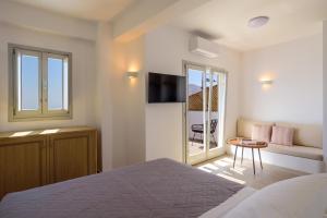 a bedroom with a bed and a balcony at Elia Pyrgos in Pyrgos +119 photos