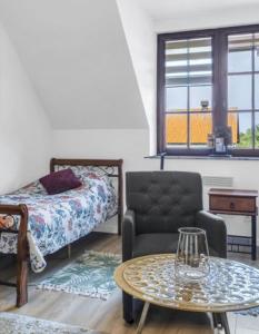 a bedroom with a bed and a table and a chair at Agroturystyka Kociołek in Kociołki