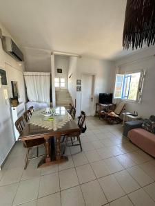 a kitchen and living room with a table and chairs at Family Apartment in Potamos Kythira in Potamós +18 photos