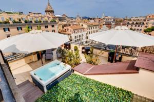 a view of the city from a balcony with umbrellas at Relais Badoer in Rome