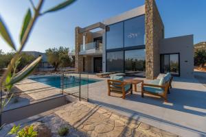 a villa with a swimming pool and a house at Ocean View 1111 Retreat in Rikia