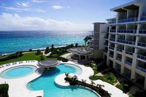 an aerial view of a resort with a pool and the ocean at Wyndham Grand Barbados Sam Lords Castle All Inclusive Resort in Saint Philip