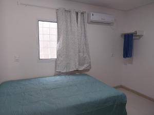 a bedroom with a bed and a window at Espaço Brisa do Mar in Olinda +3 photos