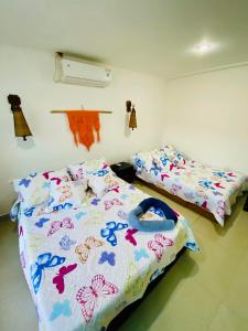 a bedroom with two beds with butterflies on them at Sol y Luna apartment in Santa Marta