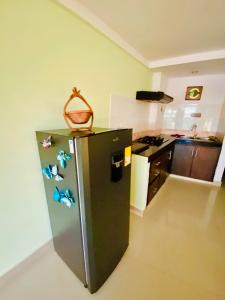 a kitchen with a refrigerator with a basket on it at Sol y Luna apartment in Santa Marta +3 photos