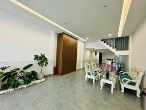 a lobby with chairs and a table in a building at Urban Hotel in Ho Chi Minh City +16 photos
