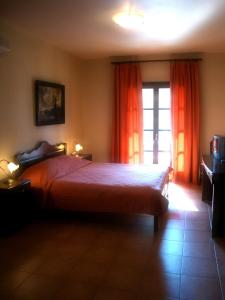 A bed or beds in a room at Enalion Hotel