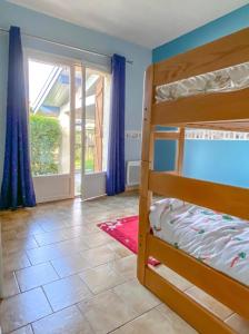 a bedroom with two bunk beds and a balcony at Le Balcon bleu de Biscarrosse in Biscarrosse