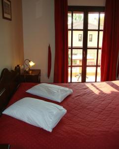 A bed or beds in a room at Enalion Hotel