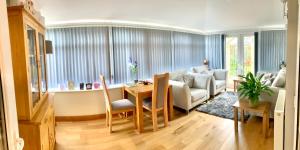 a living room with a couch and a table at Southlands B&B in Bourton on the Water