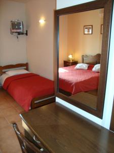 A bed or beds in a room at Enalion Hotel