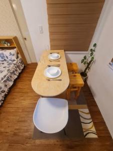 a table with two plates on it in a room at Muji-Inspired, Studio-Type Home at Phirst Park Homes Tanza in Tanza