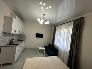 a small kitchen with a table and a couch in a room at New House Gonio in Batumi
