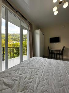 a bedroom with a large bed and a table with chairs at New House Gonio in Batumi