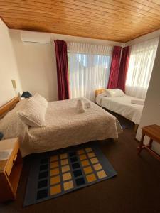 Postel nebo postele na pokoji v ubytování Hotel Küyen-Ko Pucón