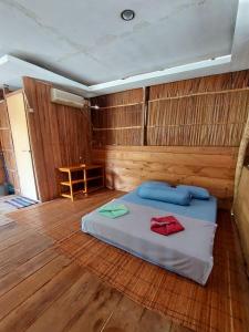 a bedroom with a bed in a wooden room at Nuttonton Homes in Papas