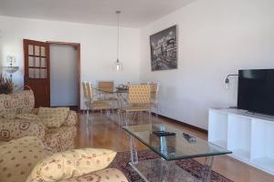 a living room with a table and a television at Casa Fatinha in Amarante